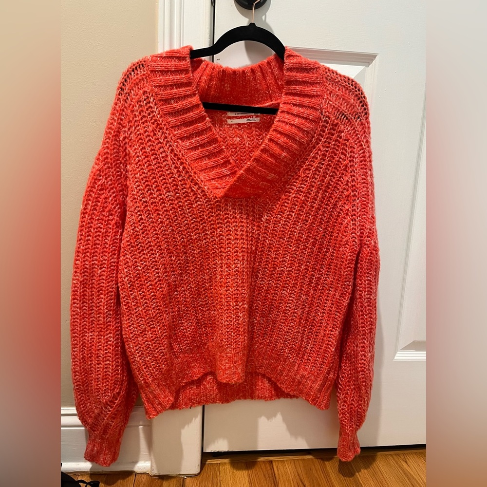 Orange Anthropologie sweater.